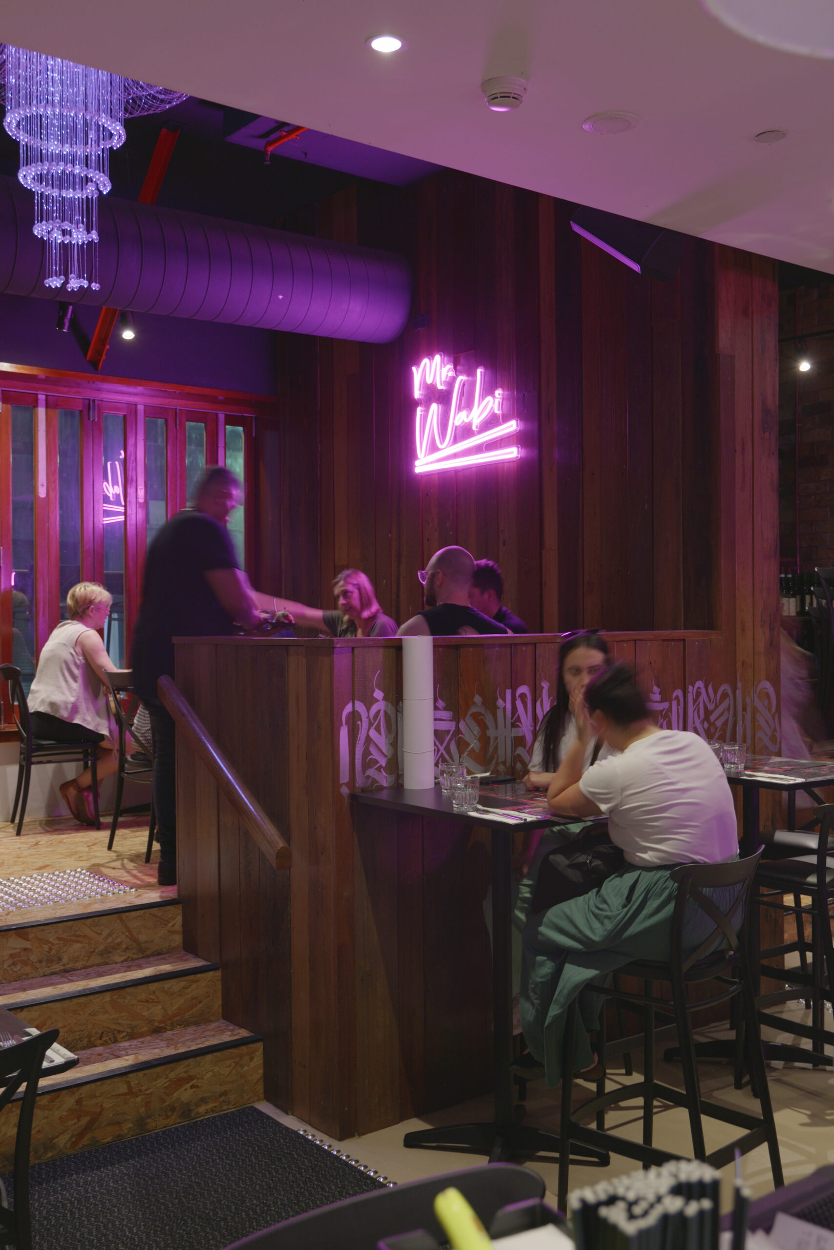 People enjoying food and drinks at Mr. Wabi, a top-rated Asian fusion restaurant in Brisbane